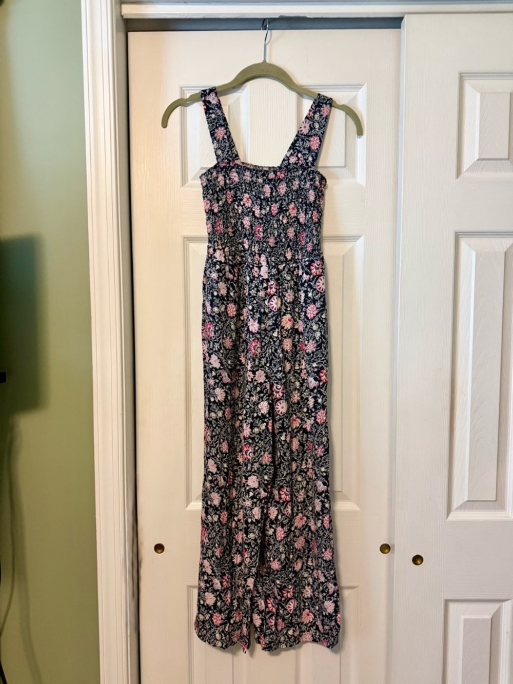 Floral Smocked jumpsuit with black background and pink accents.
